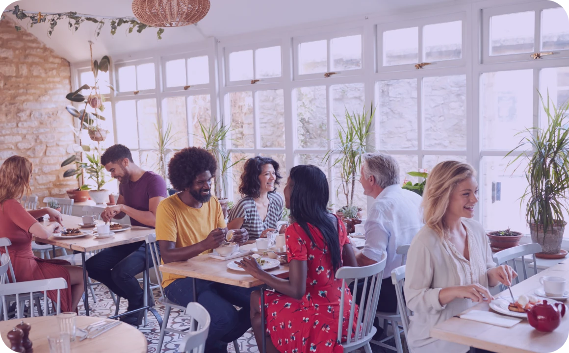 Persone che pranzano in un ristorante che utilizza TopMessage come piattaforma di comunicazione